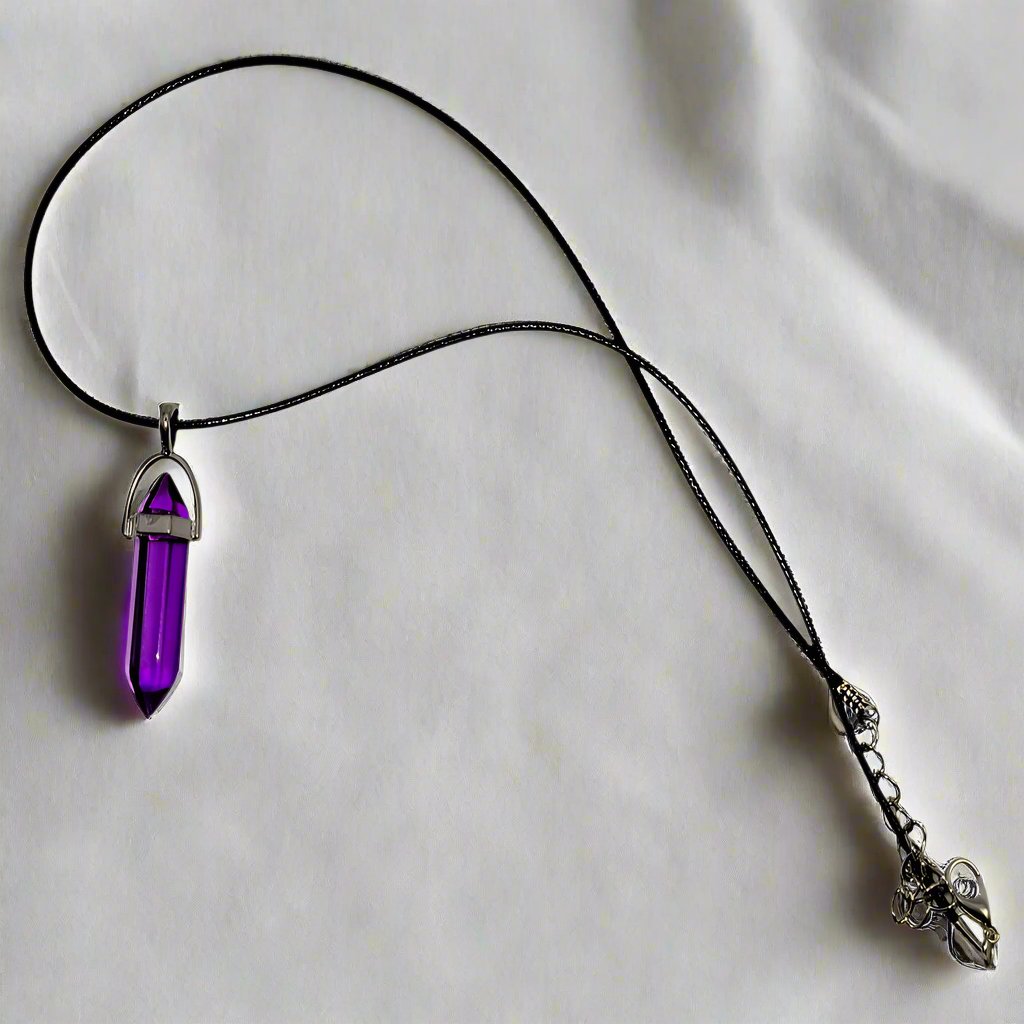 A purple wax rope necklace with a silver chain and a teardrop-shaped crystal pendant.