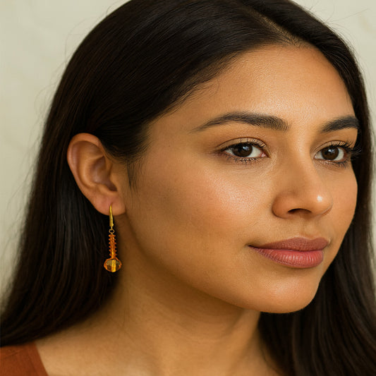 Close-up of a woman wearing an earring with a neutral background