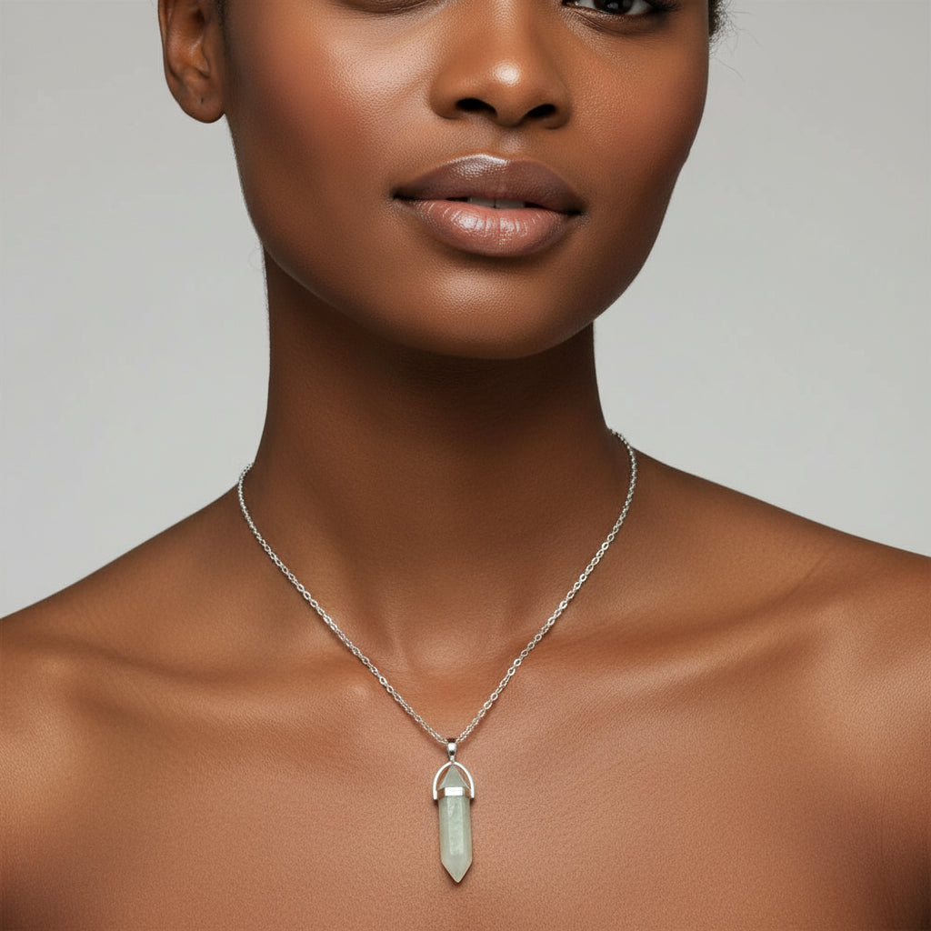A white chain necklace with a silver chain and a teardrop-shaped crystal pendant.