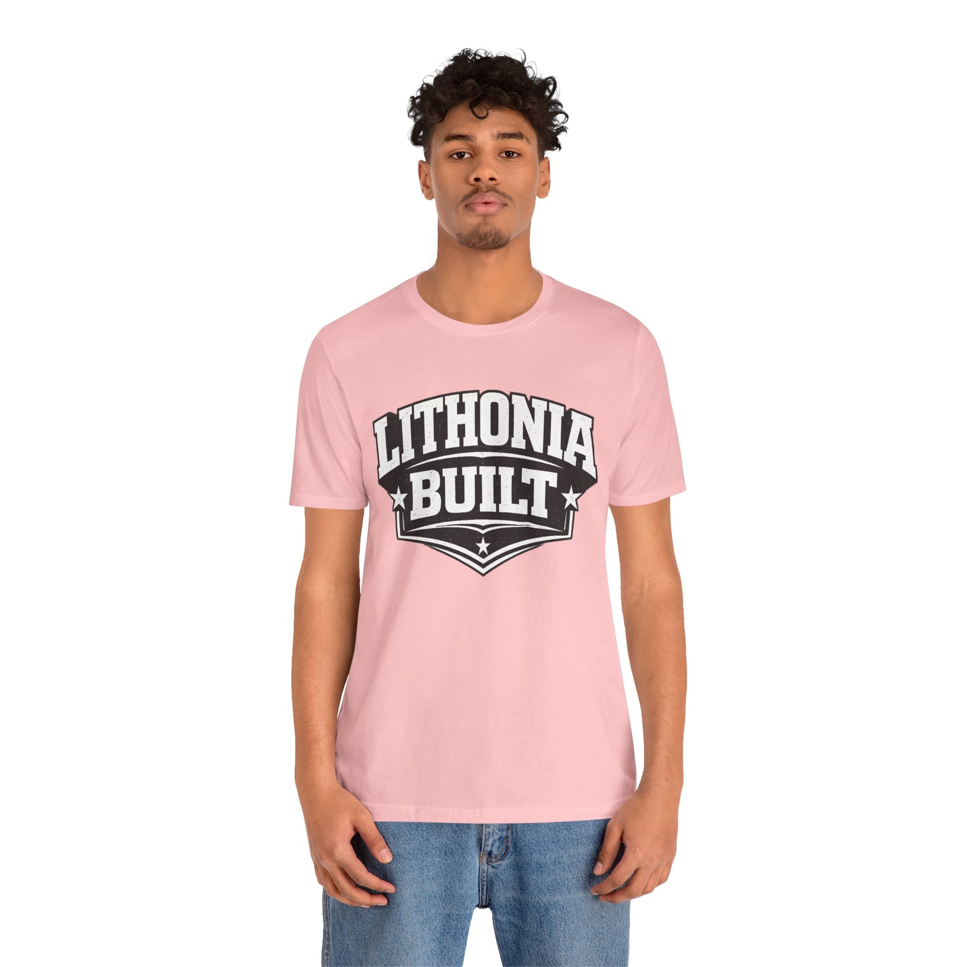 Person wearing a pink t-shirt with 'Lithonia Built' text on a white background