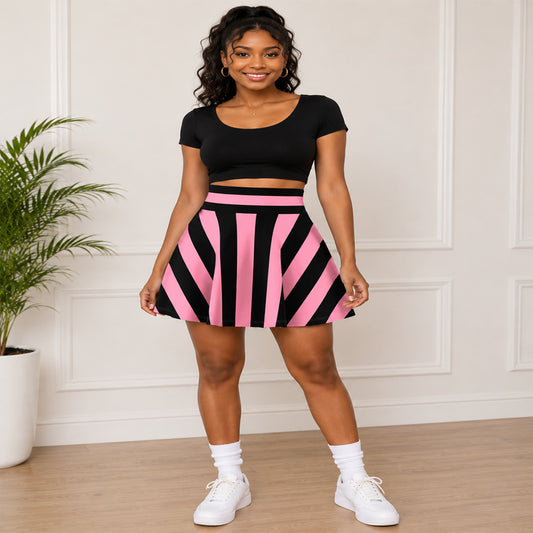 Woman wearing a black crop top and pink and black striped skater skirt in a room with a plant.