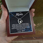 Necklace with heart design held in a box with a message for 'Mom' on a blurred background