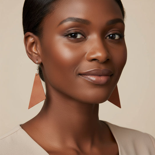 A pair of hand painted wooden triangle dangle earrings with silver hooks.